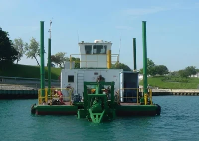 Cutter suction dredger stationary vessel performing underwater excavation