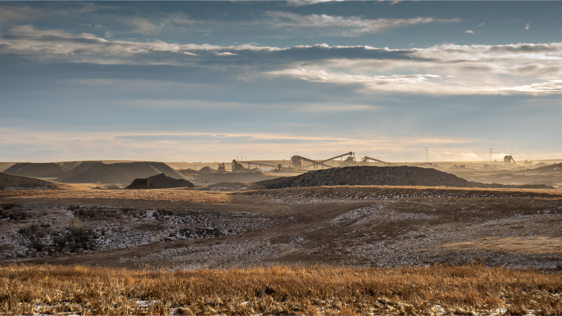 Industrial Mining Landscape with Machinery and Earth Piles A panoramic view of an industrial mining landscape