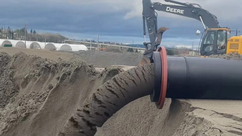 John Deere excavator operating The Egg Beater Dredge system for large-scale slurry pumping